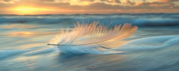 A soft feather rests on gentle ocean waves, creating a tranquil during sunset