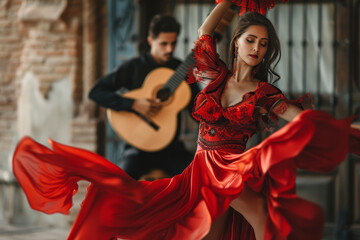 Fototapeta premium A woman in a red dress is dancing while a man plays a guitar