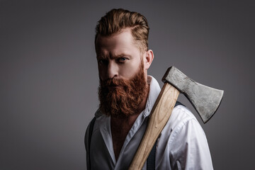 Bearded man isolated on grey. Bearded man hold ax. Hair and beard care. Handsome bearded brutal...