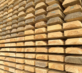 Timber planks stacked, building materials. wooden boards at lumberyard.