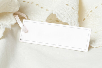 Close up of price tag of clothing item. Blank label tag mockup on clothes. Fashion industry and retail concept.