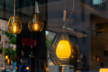 window display with three light fixtures one of which is a yellow light