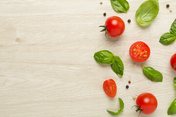 Fresh tomatoes, basil, sea salt and spices on wooden background, top view