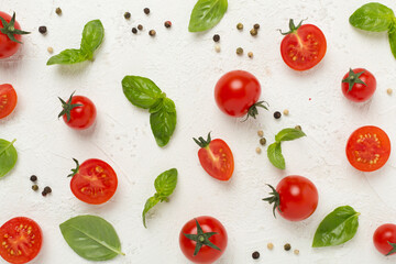 Fresh tomatoes, basil, sea salt and spices on concrete background, top view