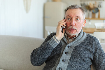 Happy middle aged senior man talking on smartphone with family friends. Older mature grandfather with cell phone talking with grown up children, resting at home. Older generation modern tech usage