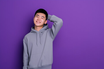 Fototapeta premium Student in hoodie and sweatpants against purple background with confident smile