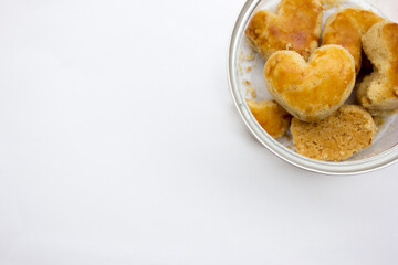 Valentine's day cookies in transparent jar on white background. Copy space for text.