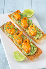 Guacamole toasts with crab claws