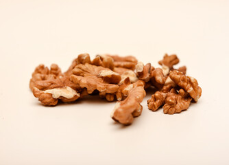 Peeled walnuts on a white background.