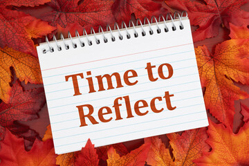 Time to Reflect on notebook with fall leaves on red wood