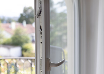 closeup of an iron part in a window frame.
switching windows to autumn-winter mode, insulating an apartment. seasonal cold snap