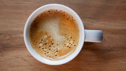 top view of a coffee mug on a wooden table