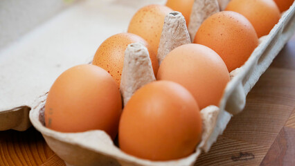A dozen chicken eggs in a box