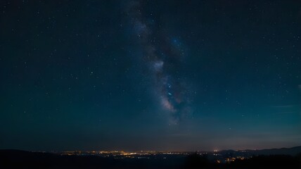Naklejka premium Night sky with glowing stars showcasing the Milky Way galaxy, complemented by city lights shining in the background, perfect for wallpaper art