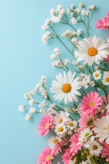 Fototapeta premium A vibrant arrangement of pink and white flowers on a light blue background in springtime