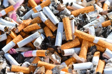 Pile of burnt cigarettes and ashes highlighting smoking impact and addiction