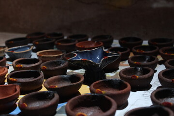 Artistic homemade clay oil lamps or karthikai deepam are ready for diwali and karthikai festivals