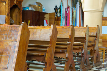 Benches in the Catholic church. The interior of the church. Places for temple visitors to pray.