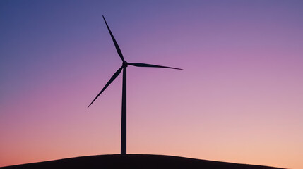 Obraz premium silhouette of wind turbine at sunset on hilltop, representing renewable energy