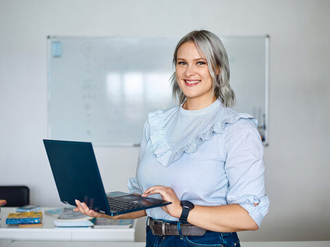 Portrait of an English teacher in a classroom against a white board background
