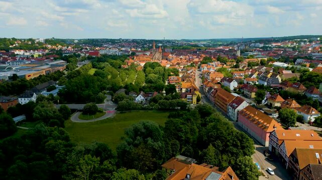 4K Aerial Drone Video of the St. Johannis Kirche Church along the Frankische Rezat River in Downtown Ansbach, Germany