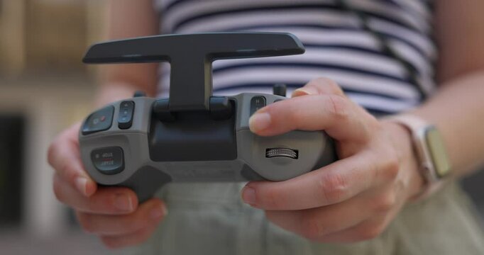 Woman's Hands Navigating Dji Avata Drone Remote Control - Close Up