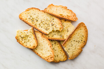 Crispy roasted bruschetta bread on kitchen table. Top view.