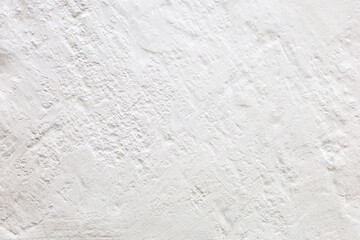 Imagem de fundo formada por um muro áspero pintado de tinta branca. 