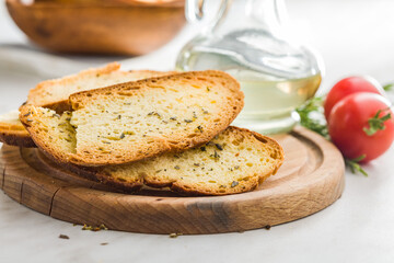 Crispy roasted bruschetta bread on cutting board.