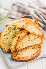 Crispy roasted bruschetta bread on cutting board.