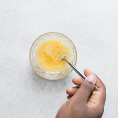 Whisking eggs and sugar together until pale, mixing eggs and sugar by hand, process of making a cake