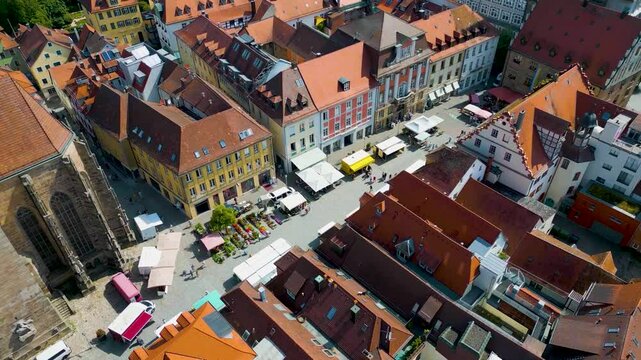4K Aerial Drone Video of Farmers Market in the Courtyard between the St. Johannis Kirche Church and Kirche St. Gumbertus Church in Ansbach, Germany