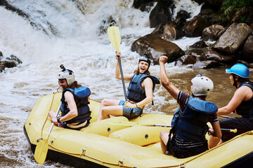 People, boat and celebrate in waterfall for rafting, sport or holiday on weekend with teamwork....
