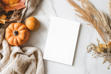 Photo of a minimalist blank journal. Autumn composition with orange pumpkins, on white background. Flat lay, top view, copy space. Mockup card design. White blank vertical sheet, paper notebook design