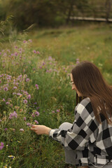 Woman Picking Wildflowers in the Field