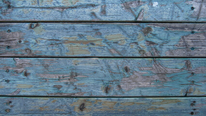 The texture of wooden boards with scratches and scuffs of paint. Old wooden backgrounds