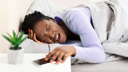 Morning Headache. Afro Woman Touching Head Suffering From Pain Lying In Bed Awaking At Home