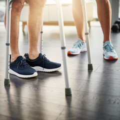 Health, physiotherapist and legs of man with walker for rehabilitation, progress and workout in clinic. Physical therapy, fitness and help for patient with mobility training, exercise gym and support