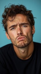 Fototapeta premium A young man showing a sorrowful expression.