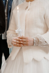 Elegant Bride Holding a Candle in a Blessed Ceremony