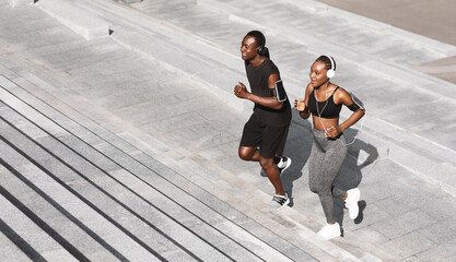 Black Man And Woman Jogging Together In Urban Park, Running Up Steps, Working Out Outdoors, Empty Space