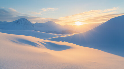 
A bright winter sunrise over a vast snowy mountain range, casting long shadows across the white expanse of snow.