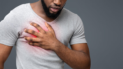 Heart attack. Young black man suffering from severe chest pain. Myocardial infarction disease,...