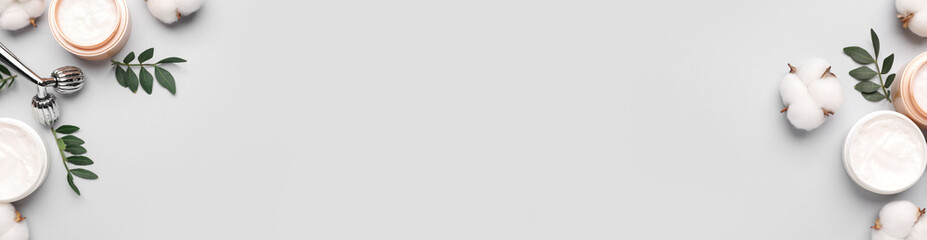 Cosmetic products and cotton flowers on light background, flat lay. Banner design with space for text