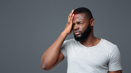 Brain diseases problem cause chronic severe headache. Young black man tired and stressed, having...