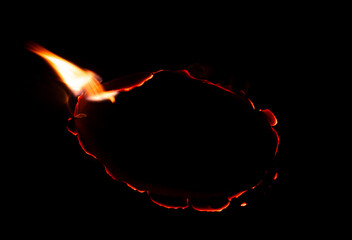 burning paper, glowing edge of paper on a black background