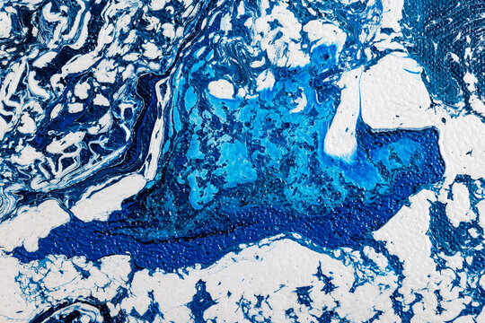 Abstract aerial view of ocean waves with blue and white paint textures