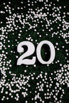 White polystyrene number 20 on green grass background