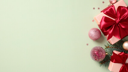 Christmas green background with gift boxes, decorations and fir branches