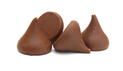 Close up pile of chocolate morsels on white background